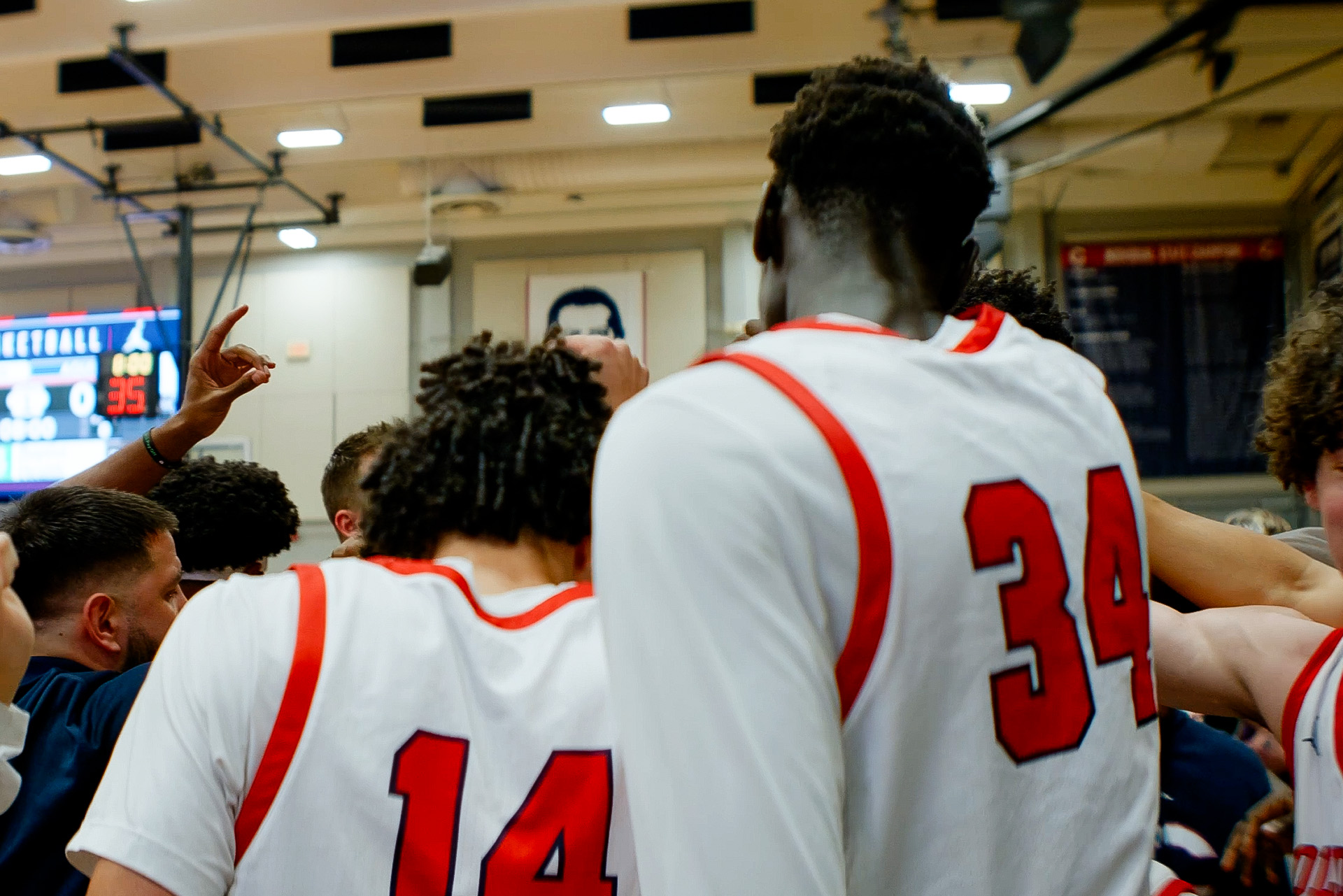 Christopher Columbus basketball comes together during a team huddle.