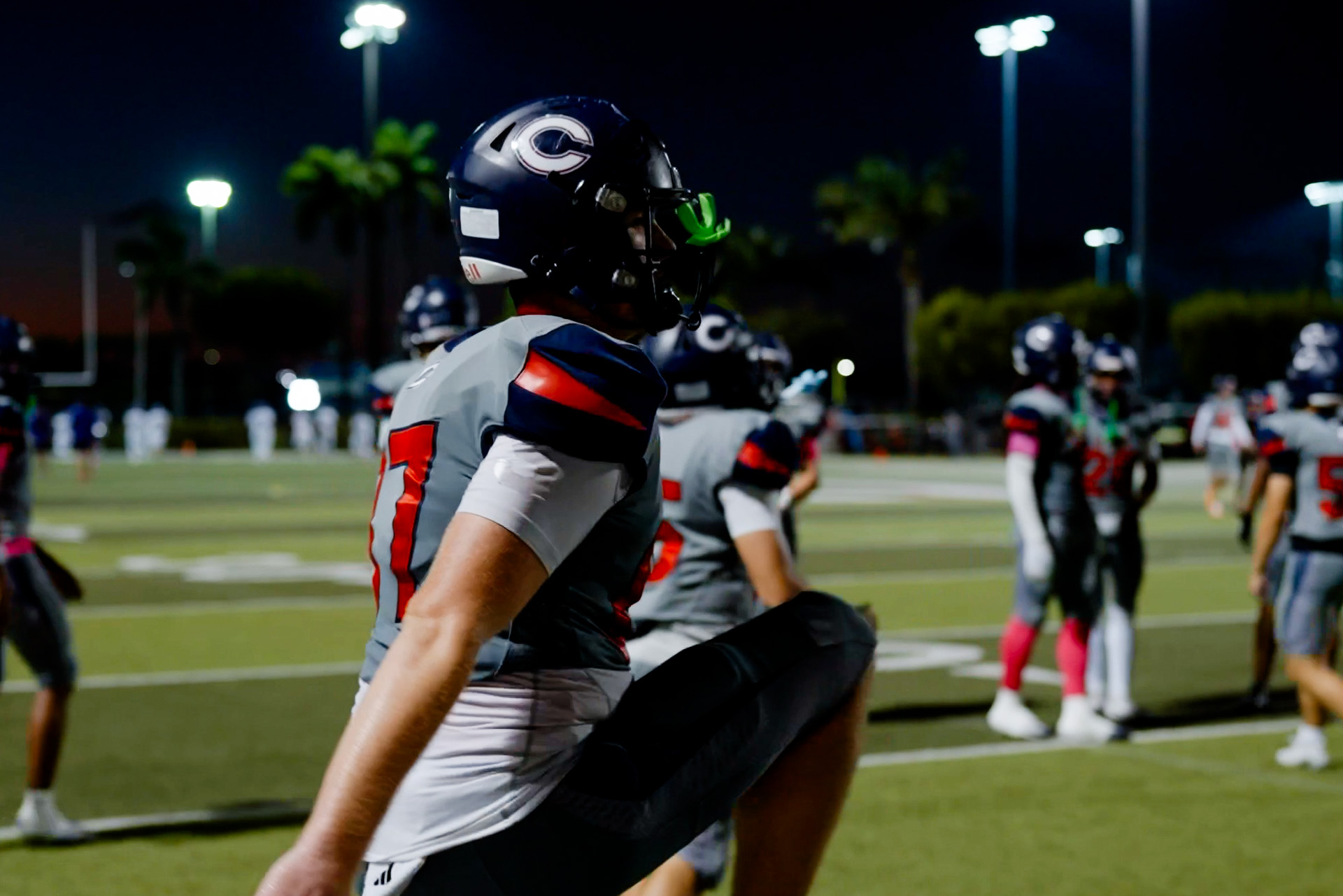 Game-night focus as Christopher Columbus football prepares under the lights.