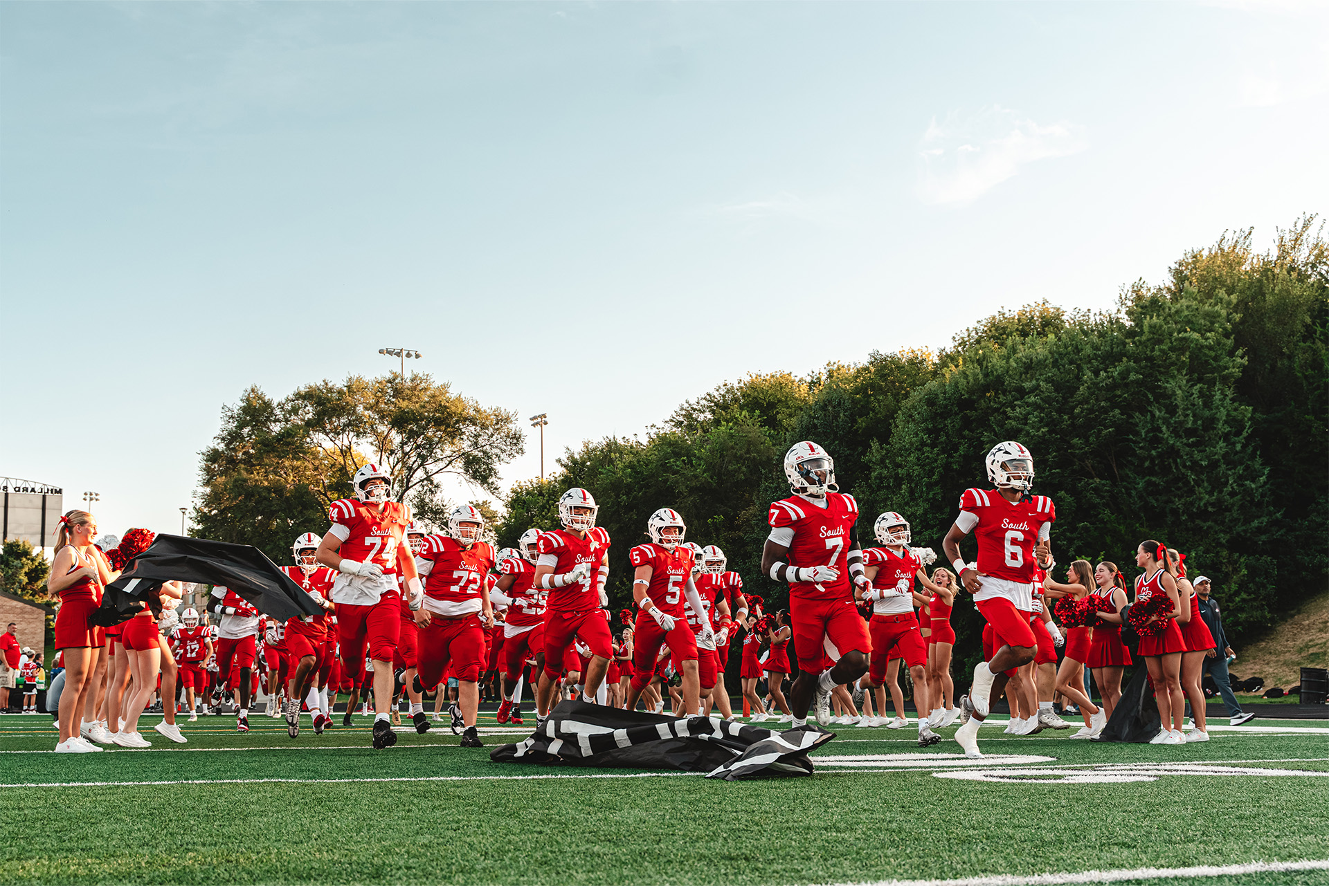 Millard South charges onto the field surrounded by Patriot pride.