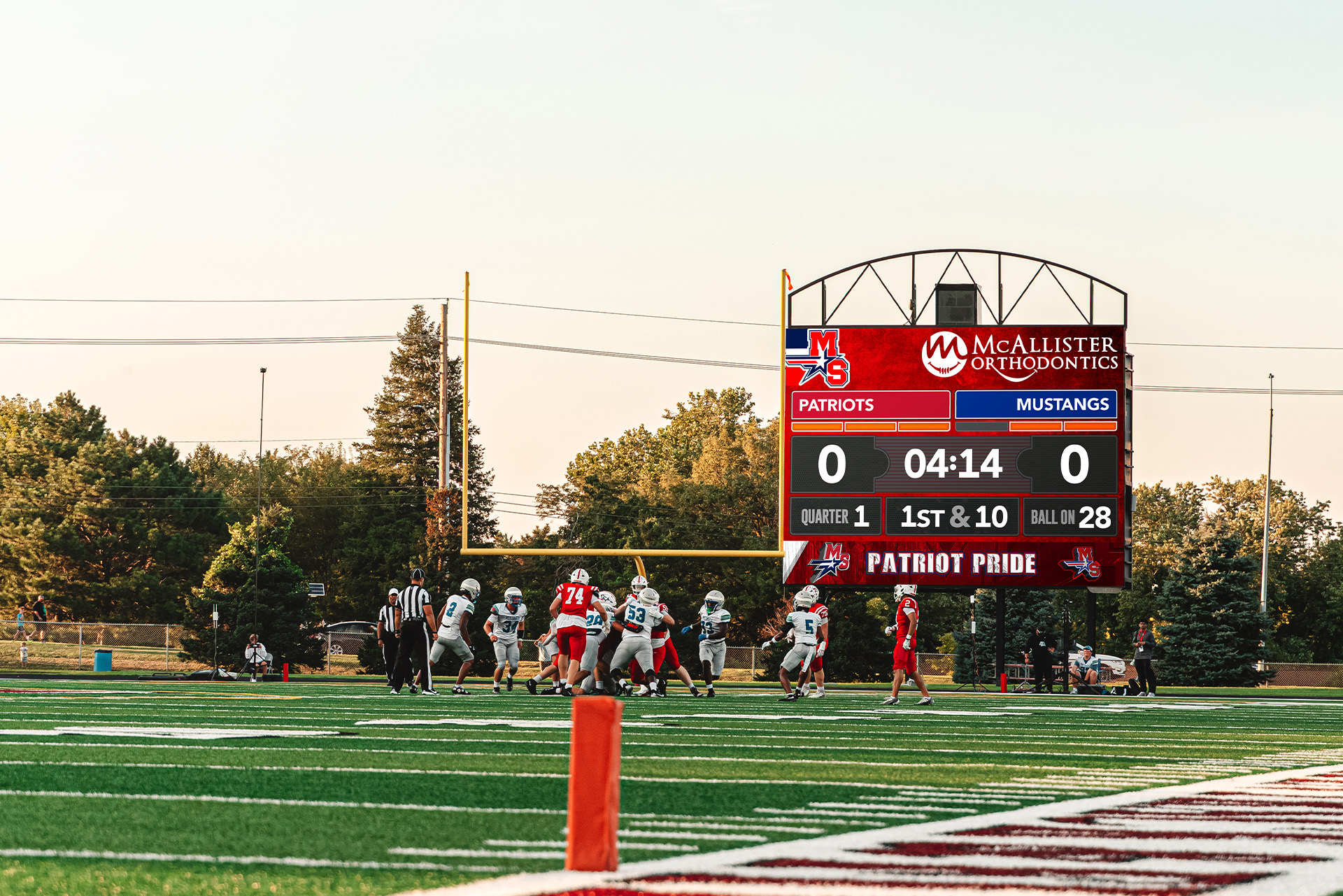 Millard South football unfolds beneath the ScoreVision display on a golden Nebraska evening.