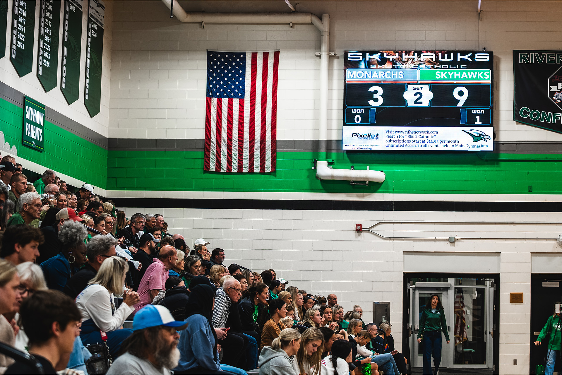 Fans follow the match beneath Skutt Catholic’s ScoreVision scoreboard.