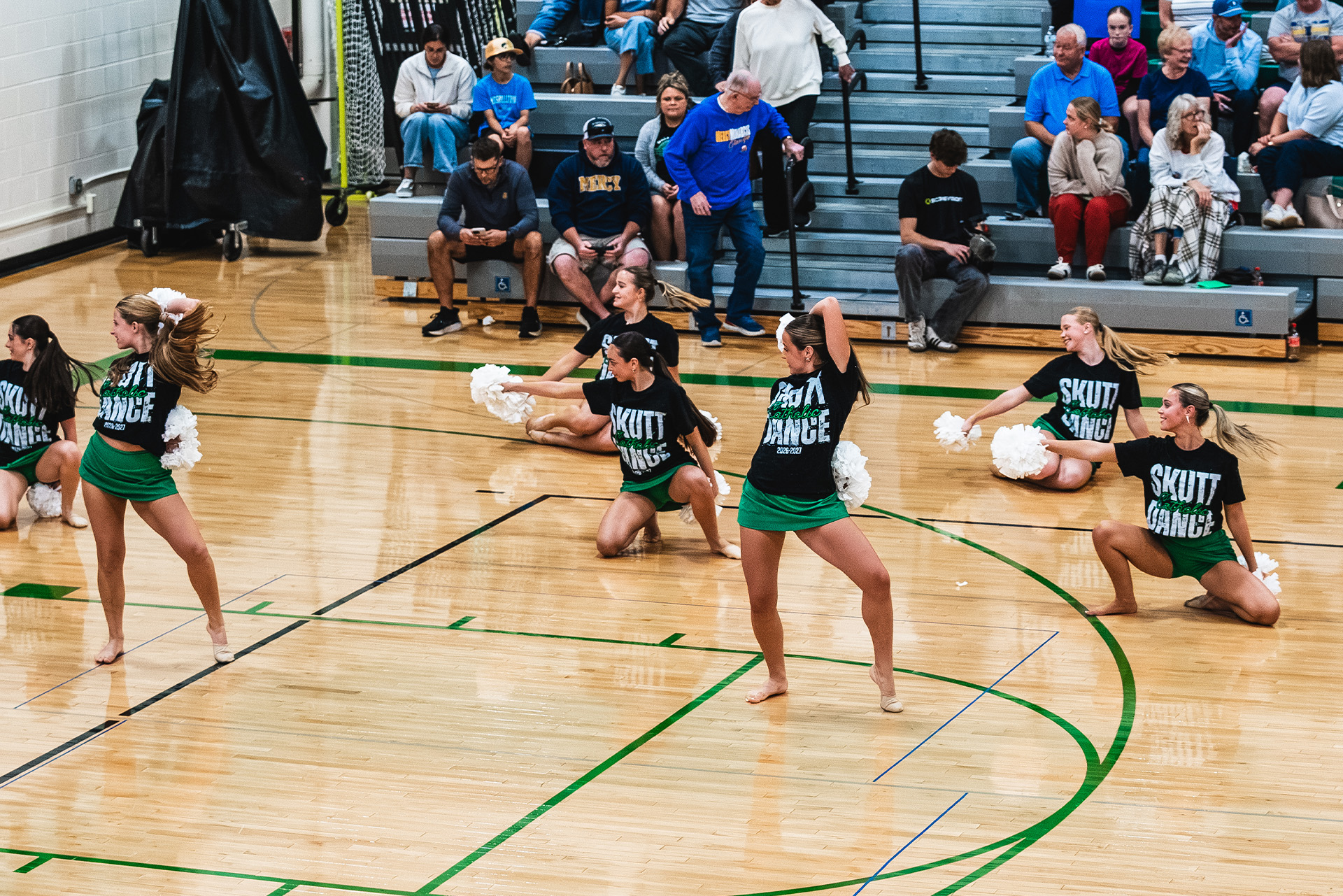 The Skutt Catholic dance team performs on the court during the match.