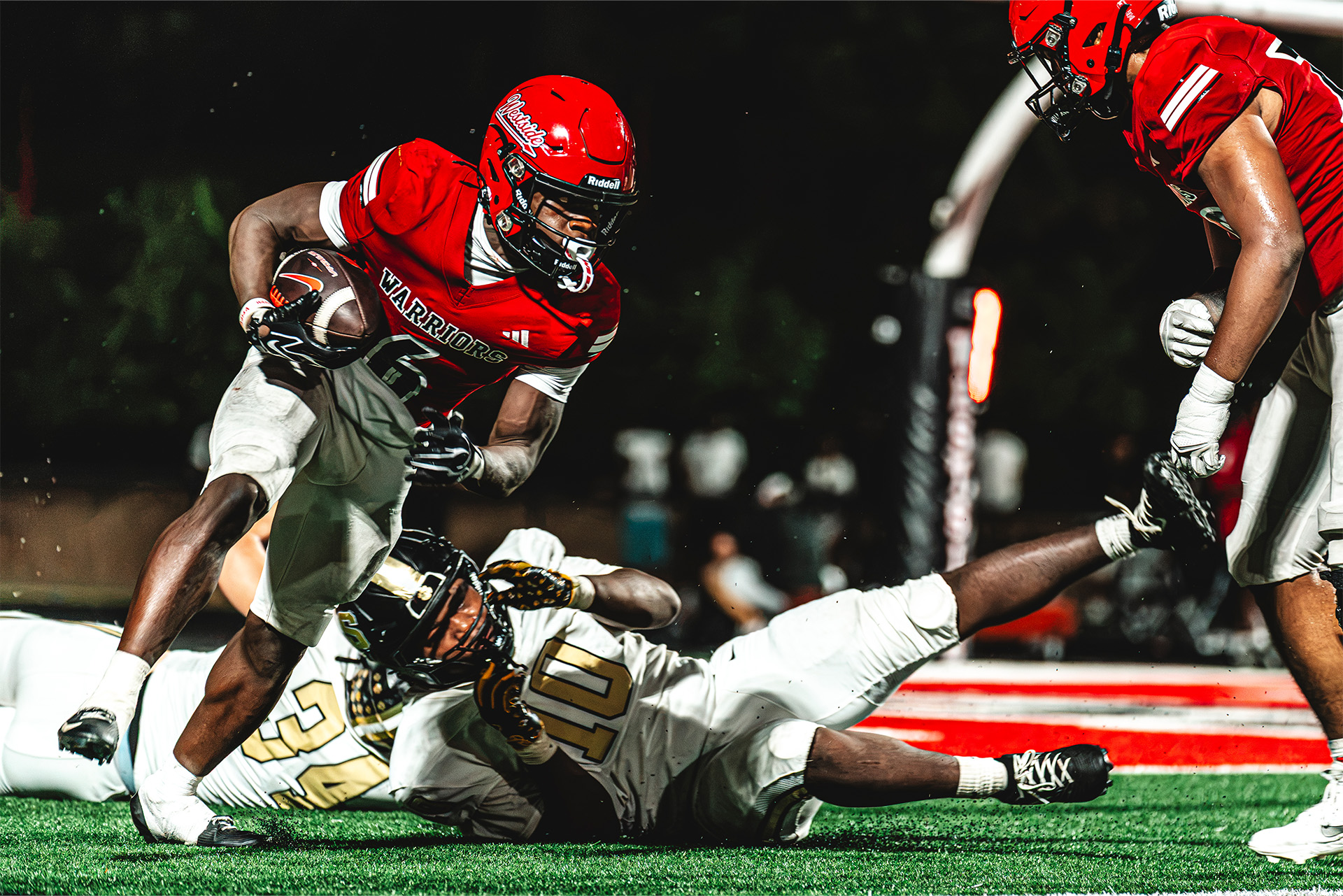 A Westside ball carrier fights through contact to keep the play moving.