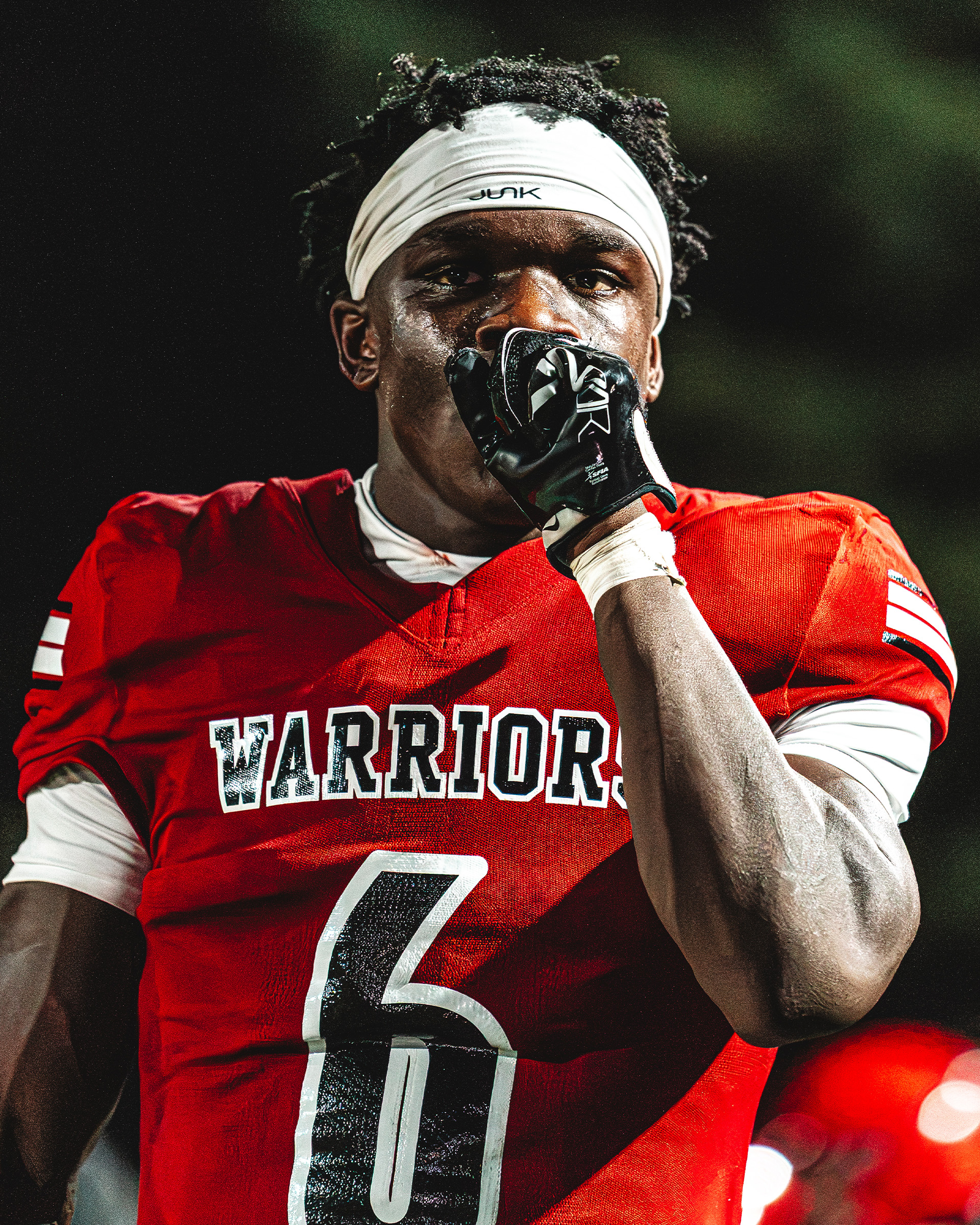 A Warriors player stays locked in under the Friday night lights.