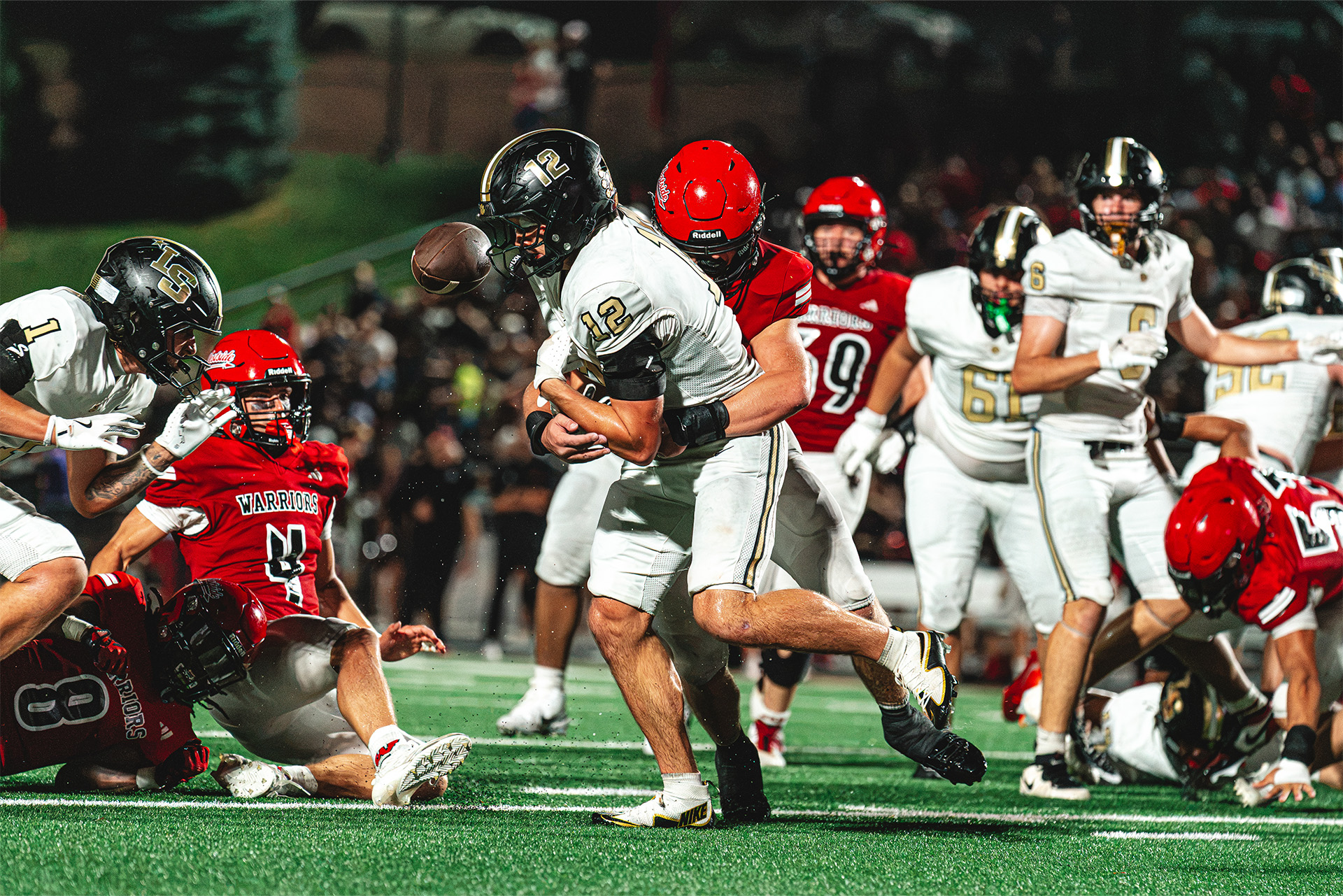 A Westside defender delivers a hard hit that knocks the ball loose.