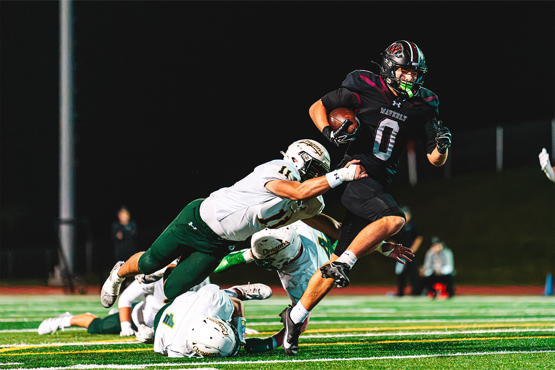 A Waverly ball carrier powers through a tackle during an action-packed night on the field.
