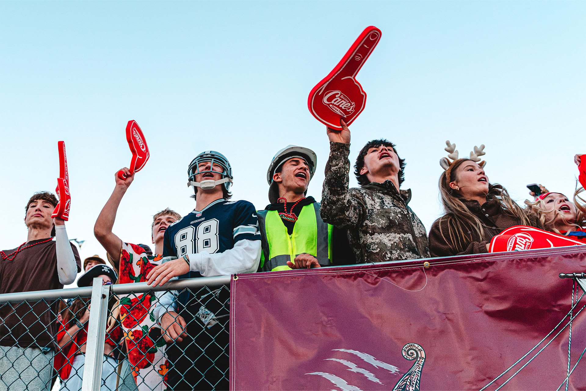 Waverly’s student section brings game-day energy with costumes, cheers, and foam fingers.