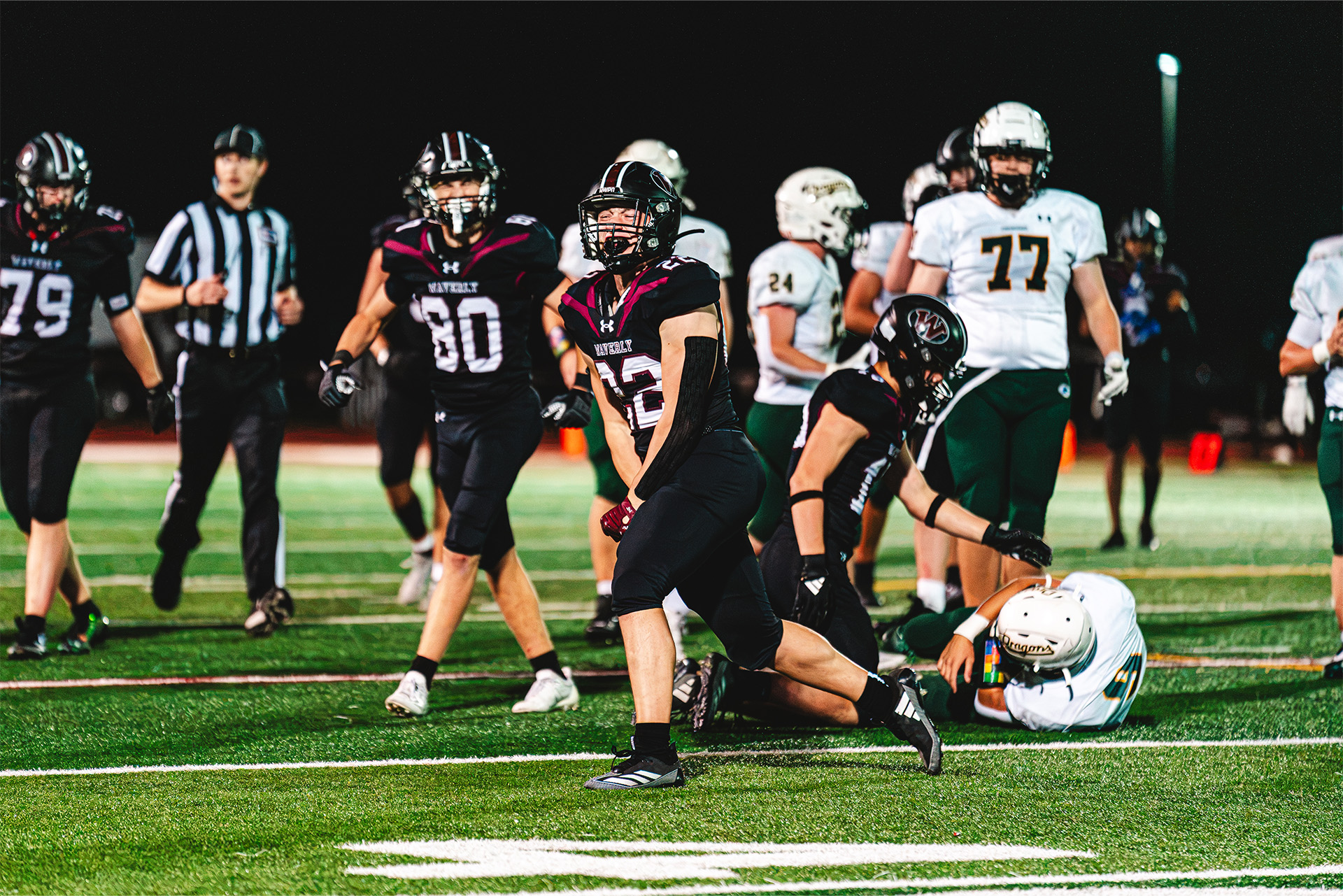 Waverly’s defense celebrates a big play under the lights.