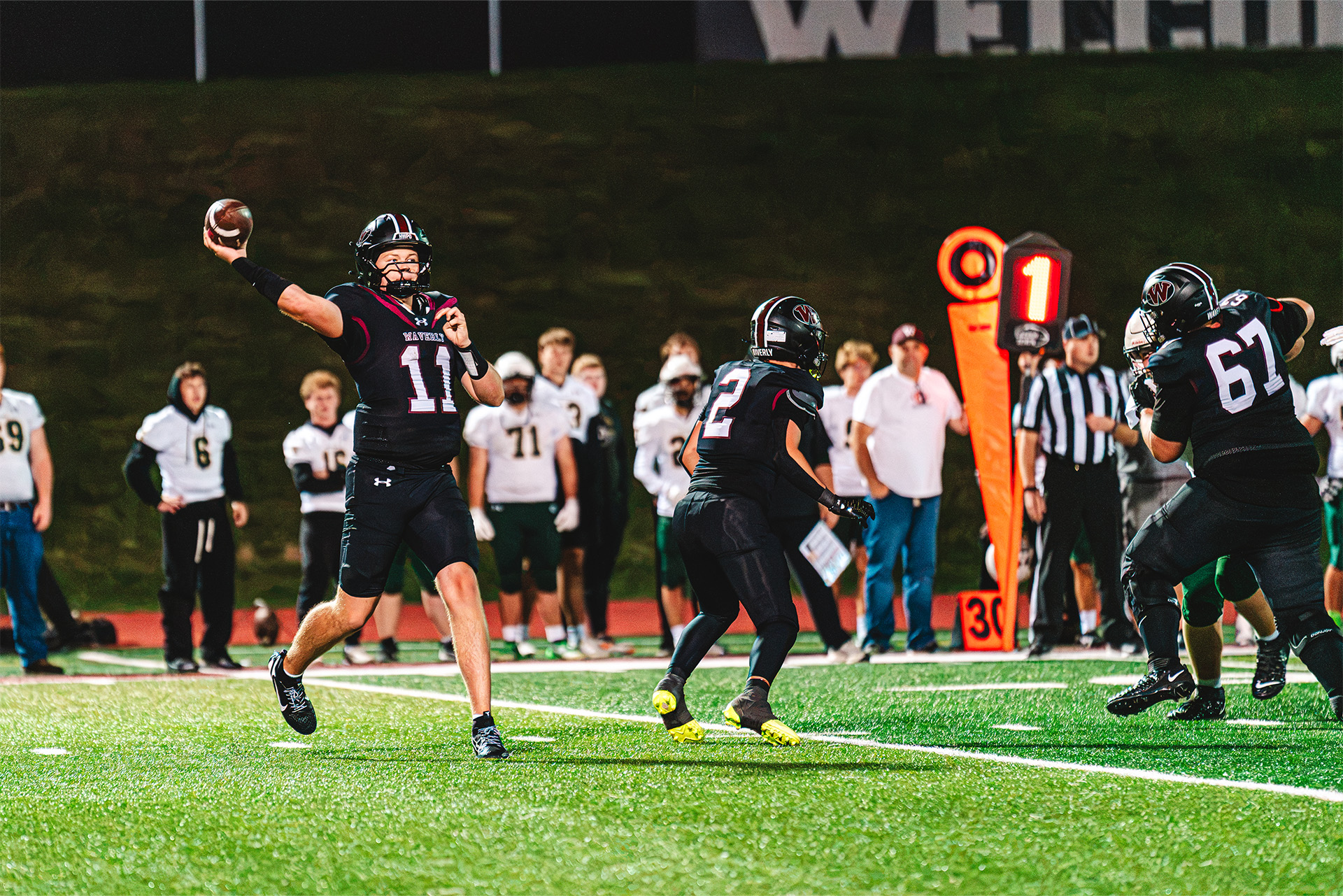 Waverly’s quarterback prepares to throw as teammates protect the pocket.